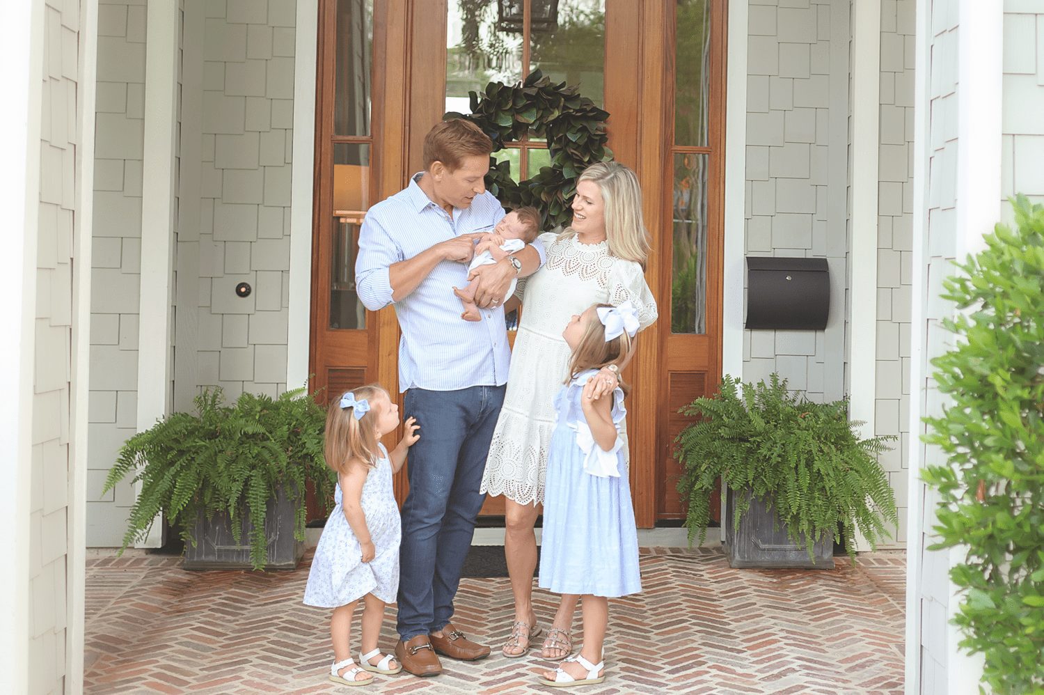 Family standing on porch