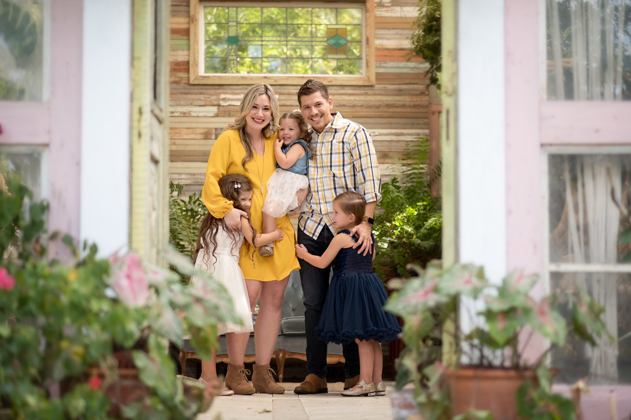 Family inside greenhouse hugging