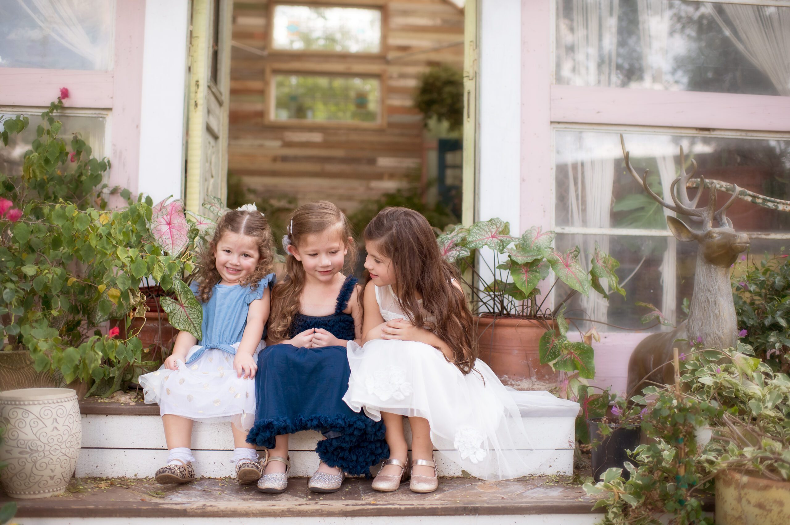 Three sisters sitting on steps