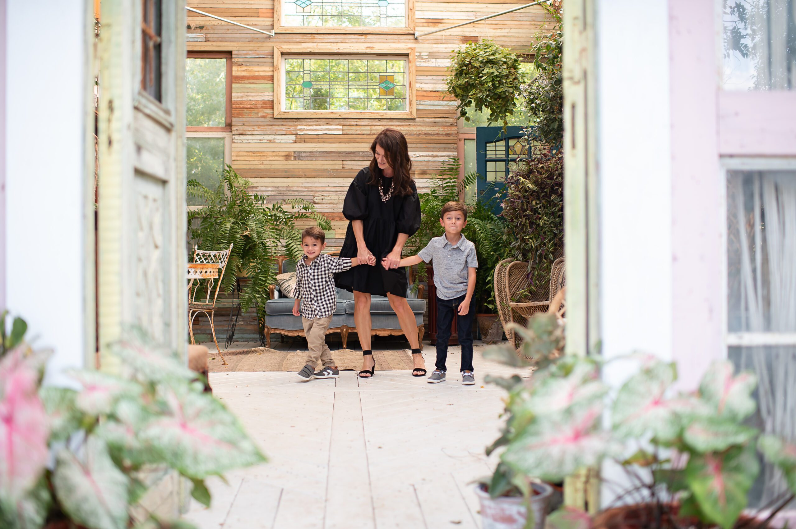 Mom with boys in greenhouse