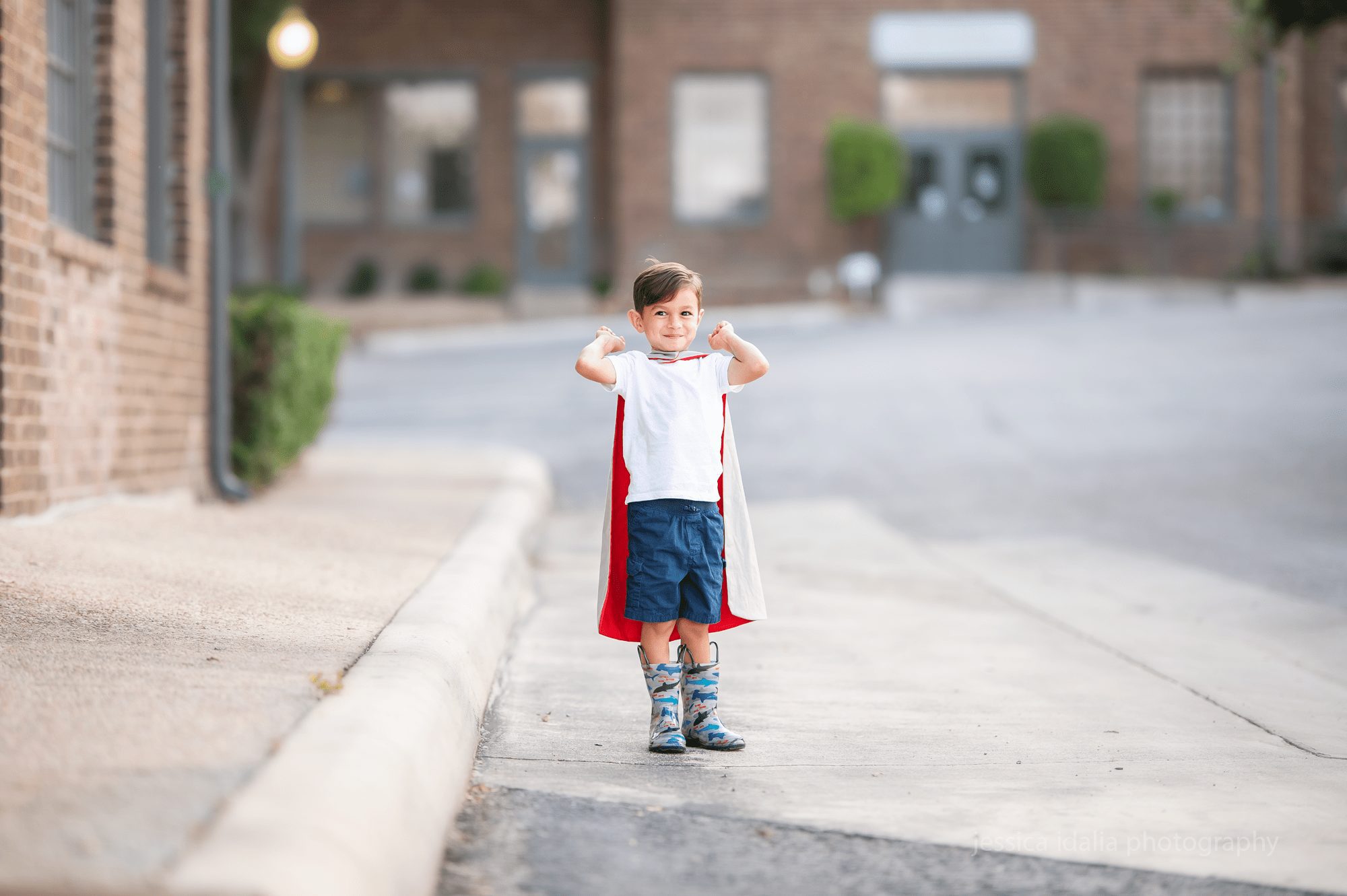 Boy wearing superhero cape child portraits