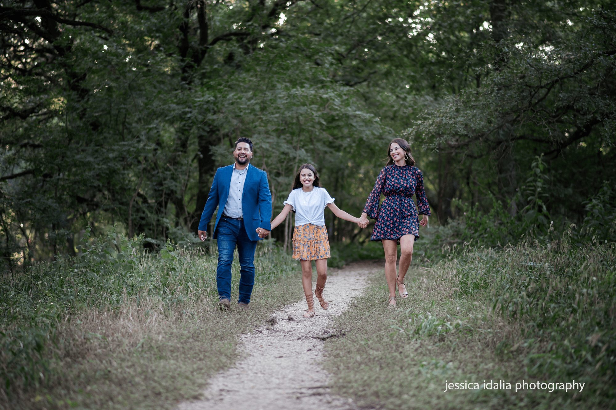 family holding hands walking on path