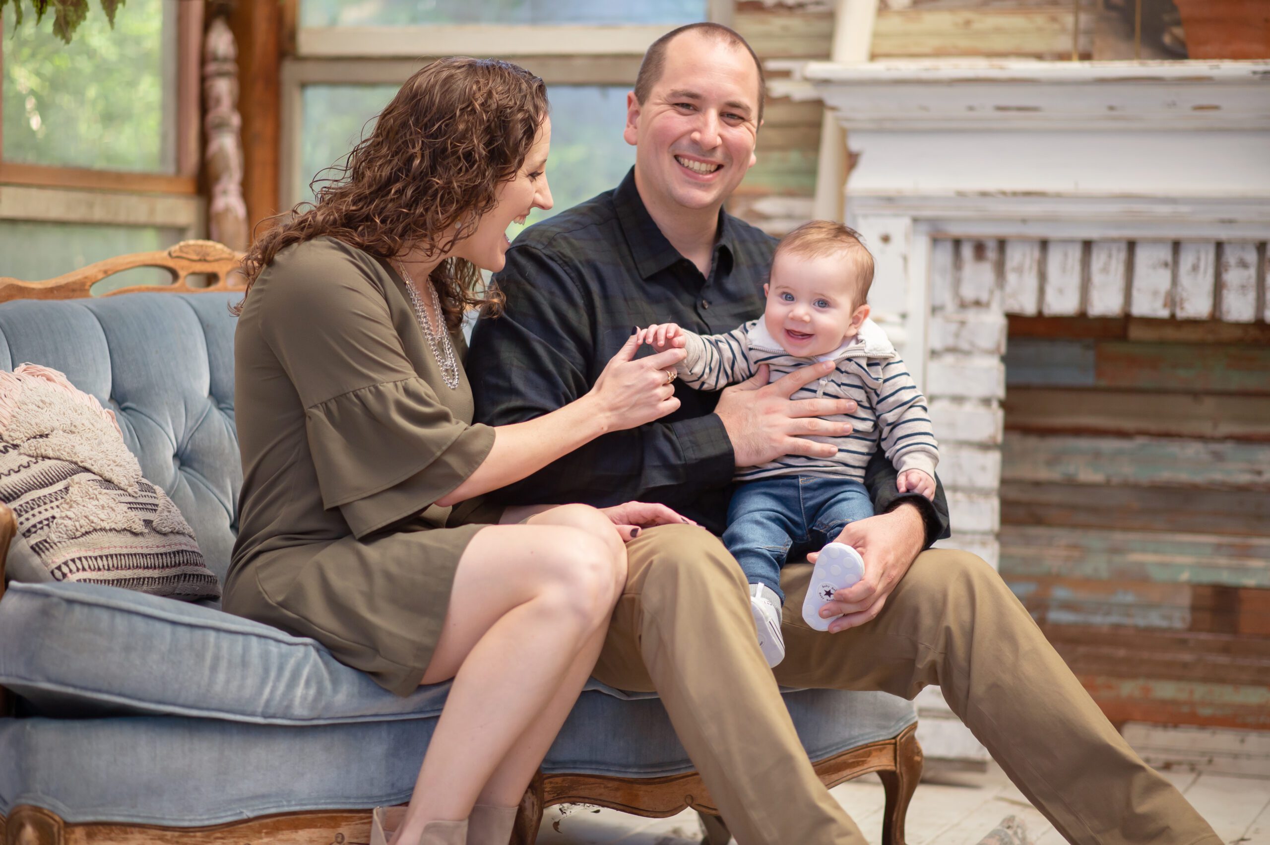 Baby and parents in greeenhouse