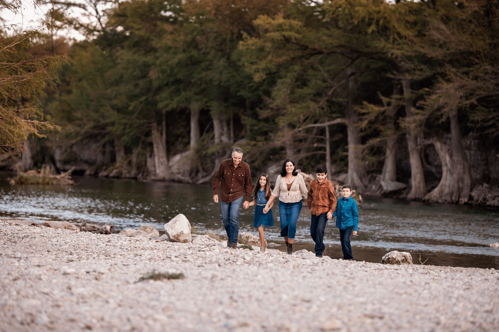 Fall Family walking by river